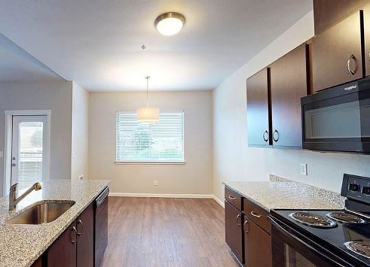 an empty kitchen with a sink and a stove