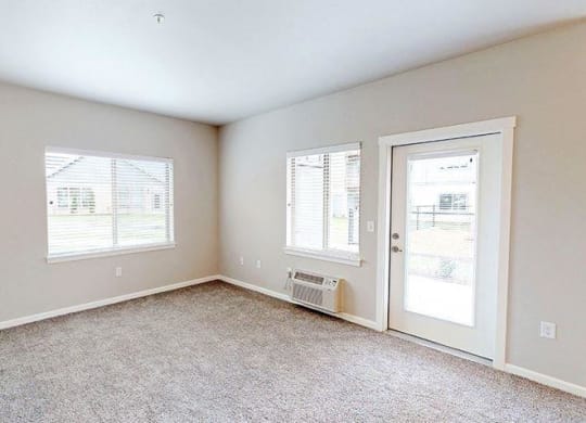 an empty room with a door and a window