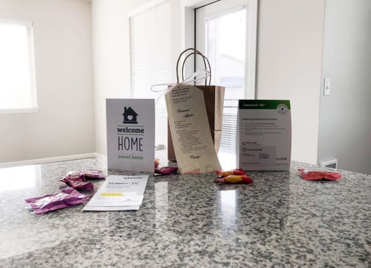 three bags sitting on a counter with some clothes on it