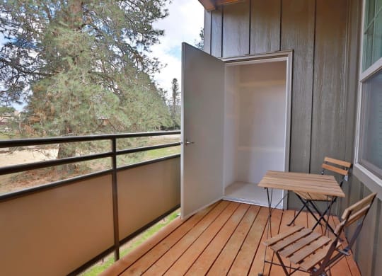 a balcony with a table and chairs on it