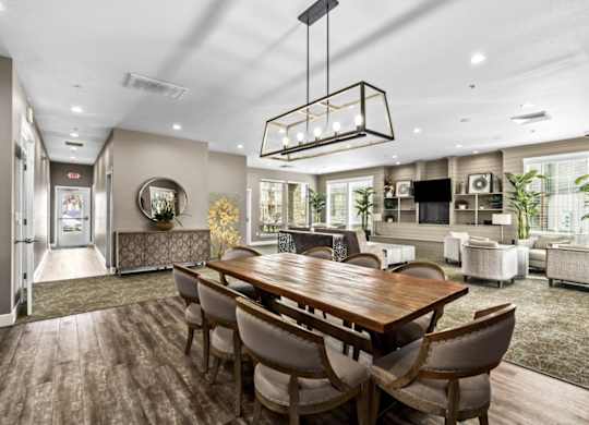 A modern dining room with a wooden table and chairs.