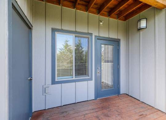 A blue door and window on a white building.