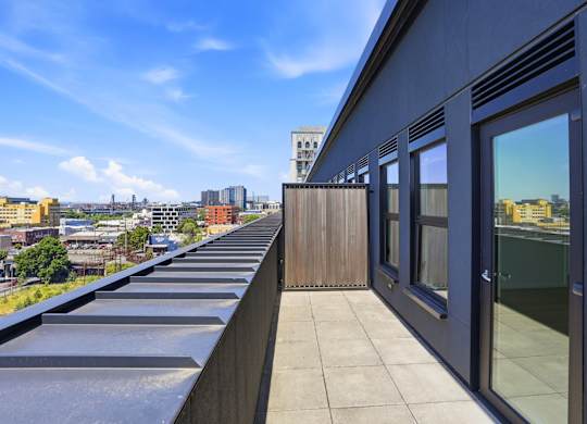A balcony with a view of the cityscape.