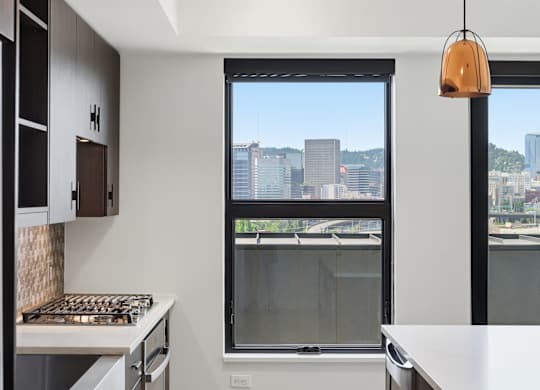 A modern kitchen with a view of the city.