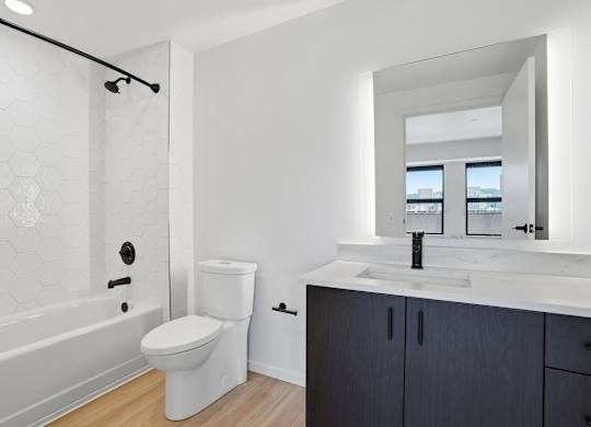 A white toilet sits next to a sink in a bathroom.