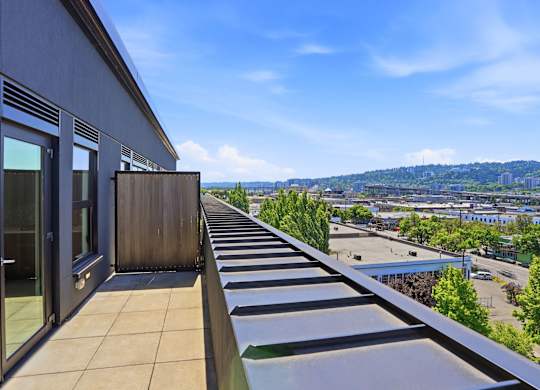 A balcony with a view of a cityscape.