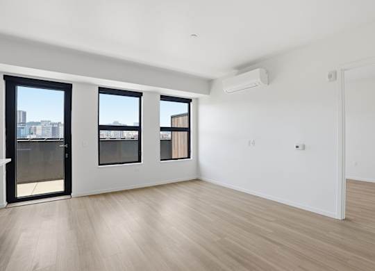 A room with a sliding door, a window, and a wall-mounted air conditioner.