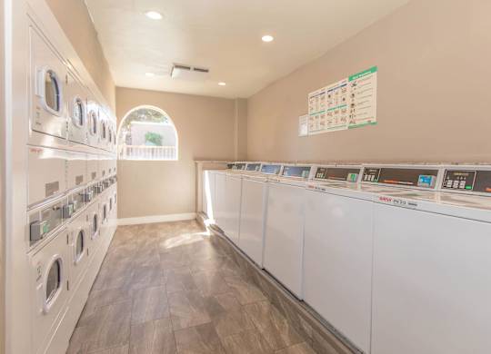 A row of washing machines in a public laundromat.
