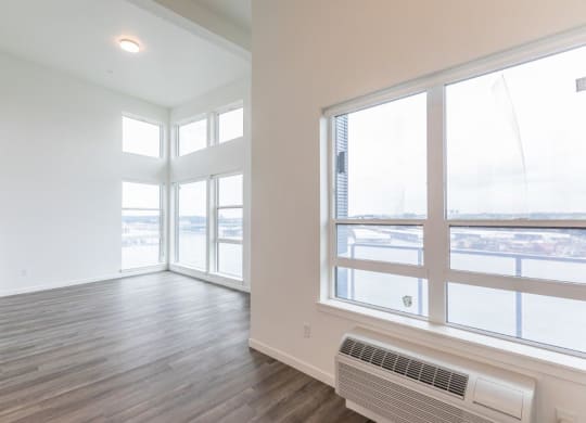 Harbor Sky Living Room with Large Windows and Private Balcony