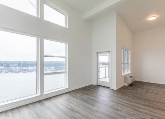 Harbor Sky Living Room with Large Windows and Private Balcony
