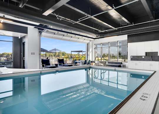 A large indoor swimming pool with a glass bottom.