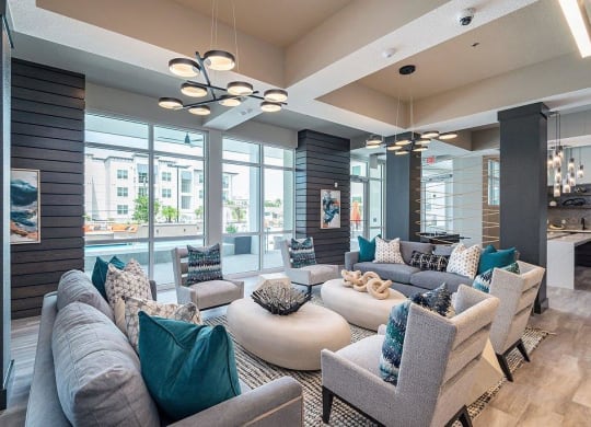 a living room filled with furniture and a large window