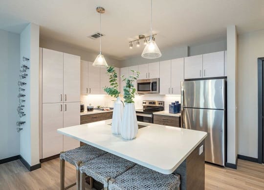 a kitchen with a refrigerator freezer next to a stove top oven