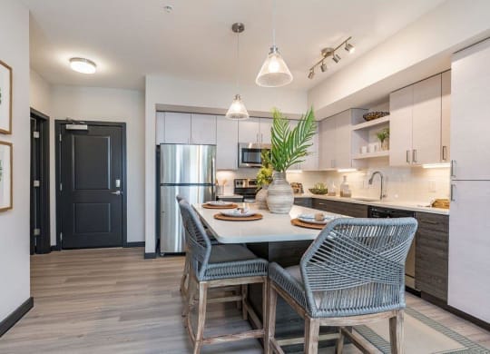 a kitchen with a table and chairs and a refrigerator