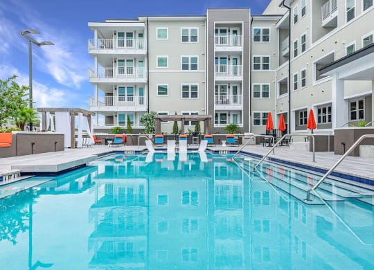 a swimming pool with a building in the background