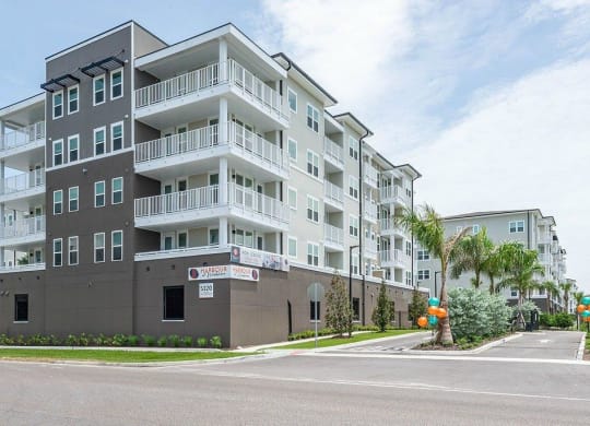 a large apartment building with a sign in front of it