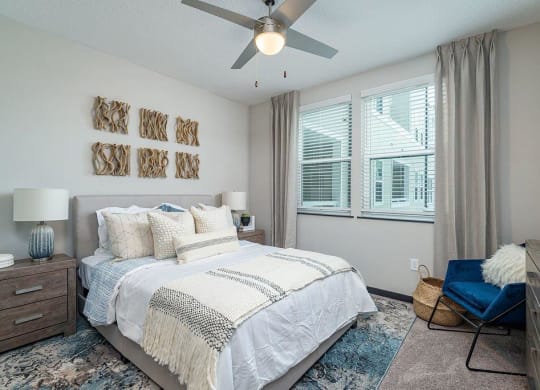 a bedroom with a bed and a ceiling fan