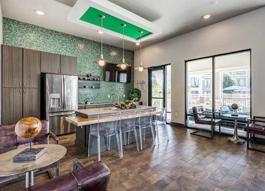 A modern kitchen with a bar area and a view of the city.