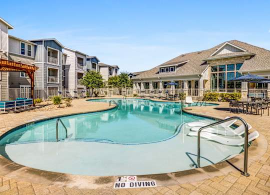 A pool with a no diving sign in the middle.