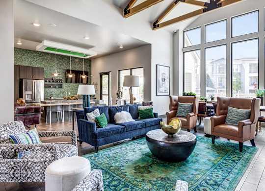 A living room with a blue couch and a large window.