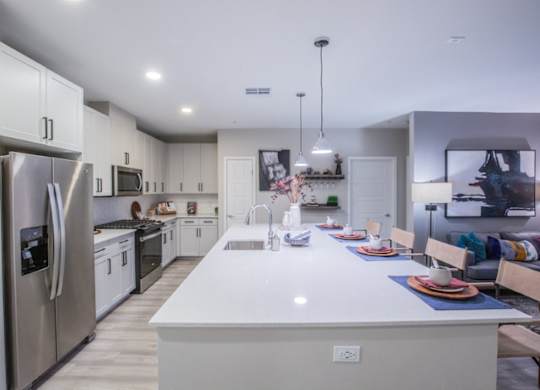 A modern kitchen with a large island and stainless steel appliances.