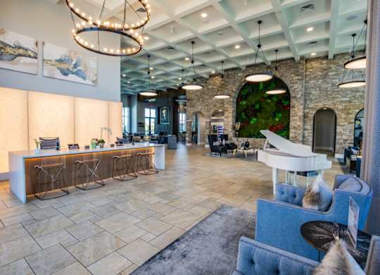 A reception area with a white piano and a reception desk.