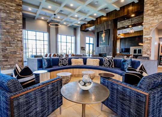 A living room with a stone pillar and a blue couch.