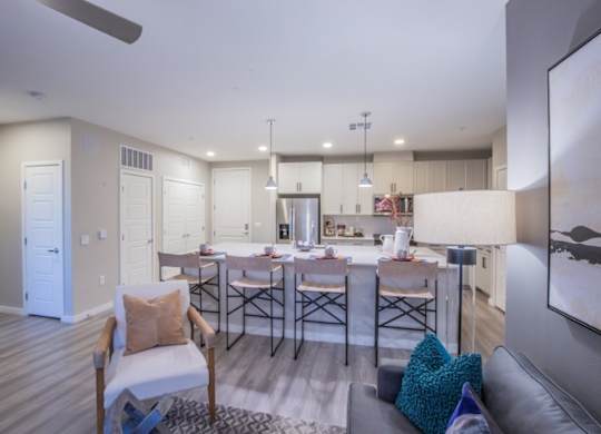 A modern kitchen with a dining table and chairs.