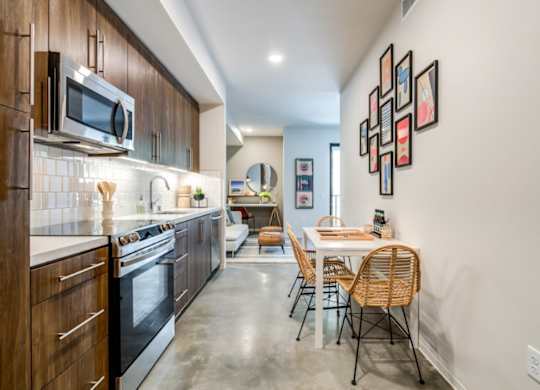 A modern kitchen with a dining table and chairs.