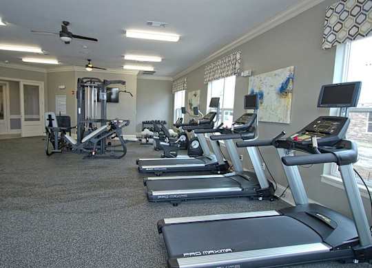 A gym with treadmills and exercise bikes.