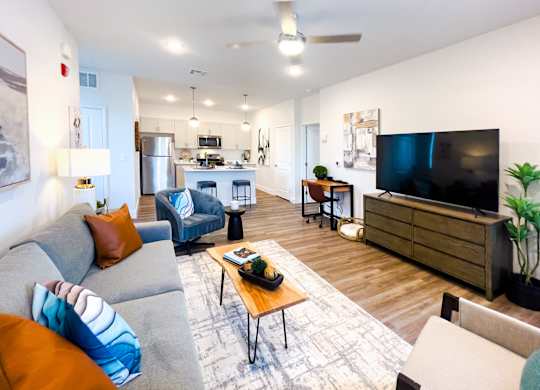 A living room with a grey couch and a wooden coffee table.