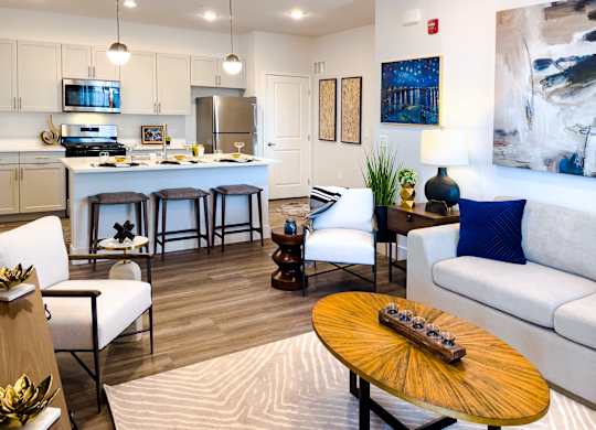 A modern living room with a wooden coffee table and a white couch.