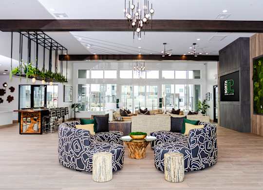 A modern living room with a large sofa and a chandelier.