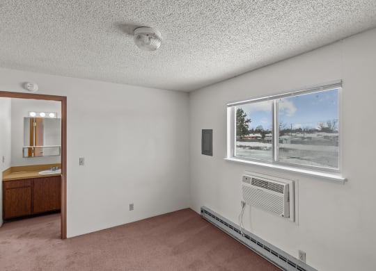 the living room of an empty house with a window