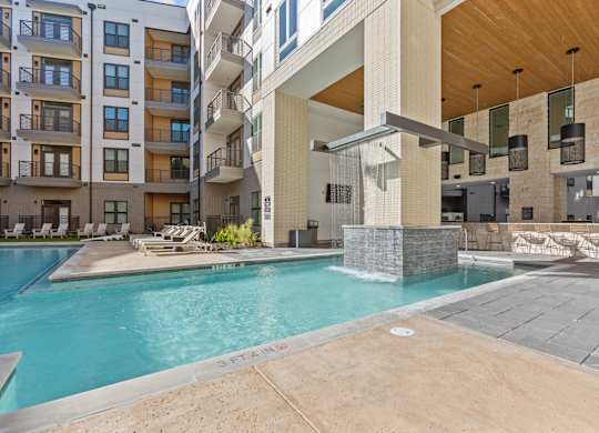 A swimming pool in front of a modern building.
