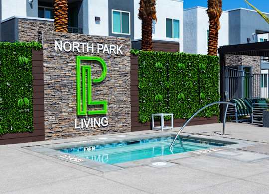A pool in front of a wall with North Park Living written on it.