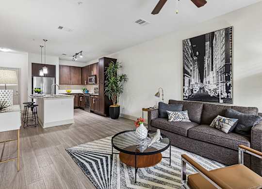 A living room with a grey couch and a coffee table.