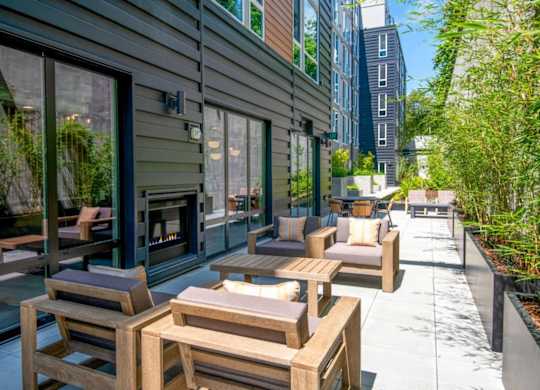 A patio with wooden furniture and a fireplace.