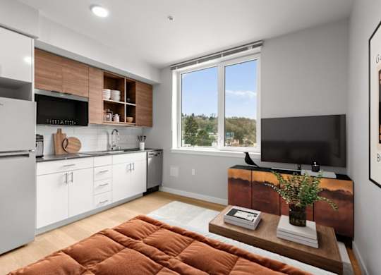 A modern kitchen with white cabinets and a wooden countertop.
