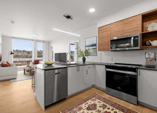 A modern kitchen with a large island and stainless steel appliances.