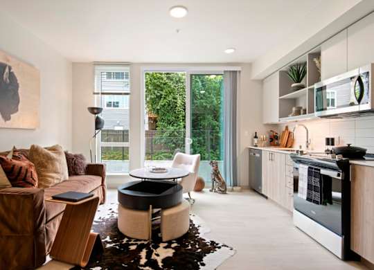A modern living room with a brown couch and a cowhide rug.