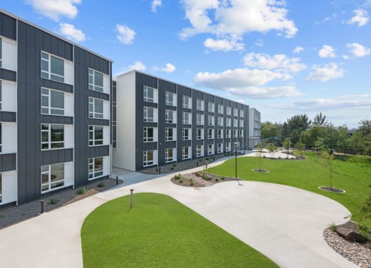 an exterior view of a building with green grass and a sidewalk at Ironside Apartments, Spokane , WA