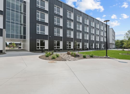 a large apartment building with a large sidewalk and grassy area at Ironside Apartments, Washington, 99202