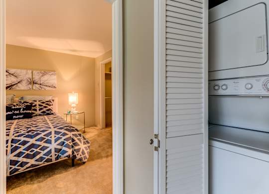 A bedroom with a bed and a white oven in the same room.