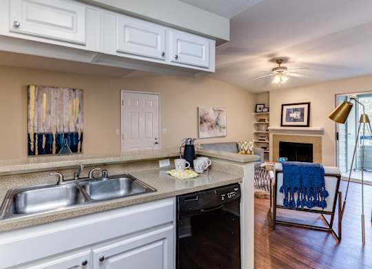 A kitchen with a sink, stove, and oven.