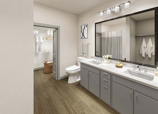 A bathroom with a toilet, sink, and mirror.