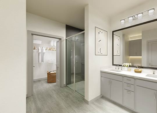 A bathroom with a mirror, sink, and a glass door.