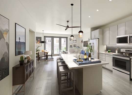 A modern kitchen with a large island and a dining area.