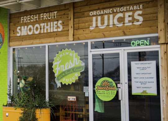 the front of a fruit juice shop with the door open