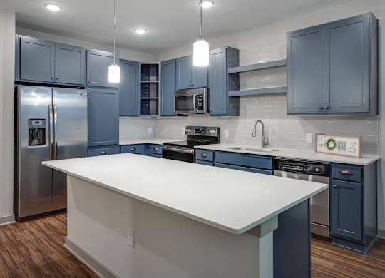 a kitchen with blue cabinets and a white island
